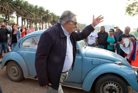 Jos Mujica standing near a light blue VW bug.
