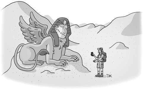 Explorer holding up phone in front of Sphinx. Explorer holding up phone in front of Sphinx.