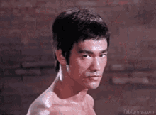 a close up of a man 's face with bruce lee 's face covered in sweat .